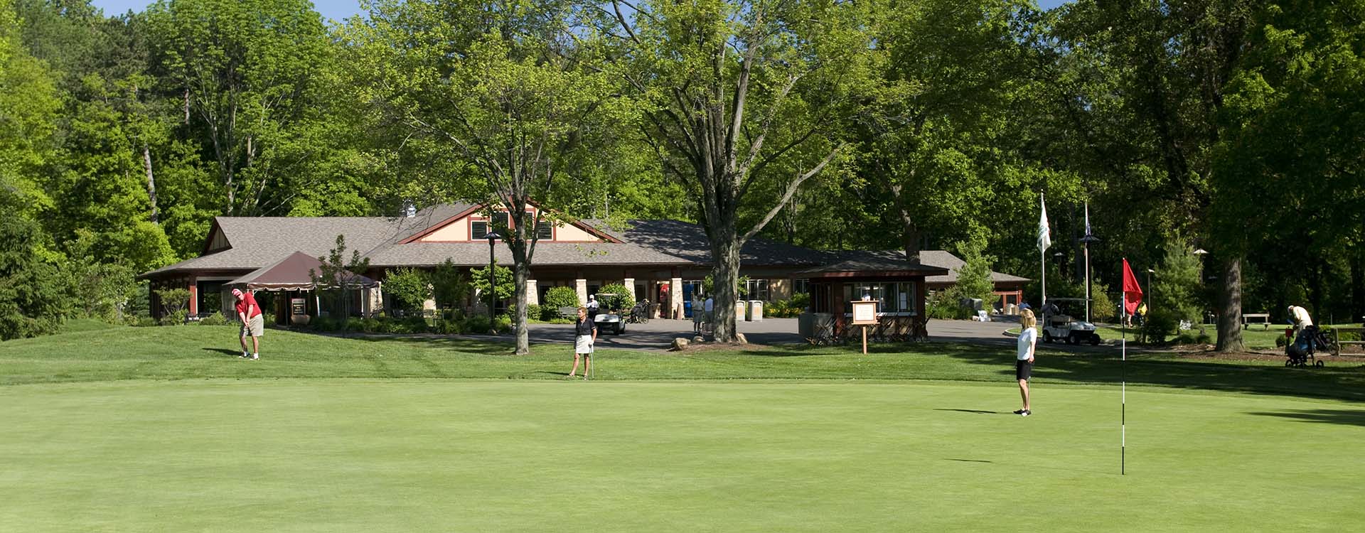 People golfing on a golf course