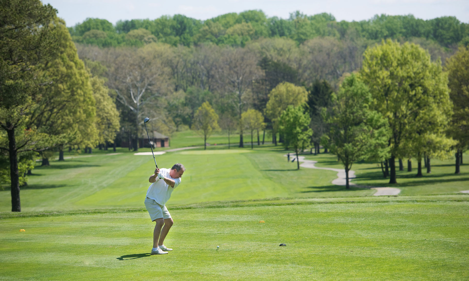 A man swinging a golf club on a golf course