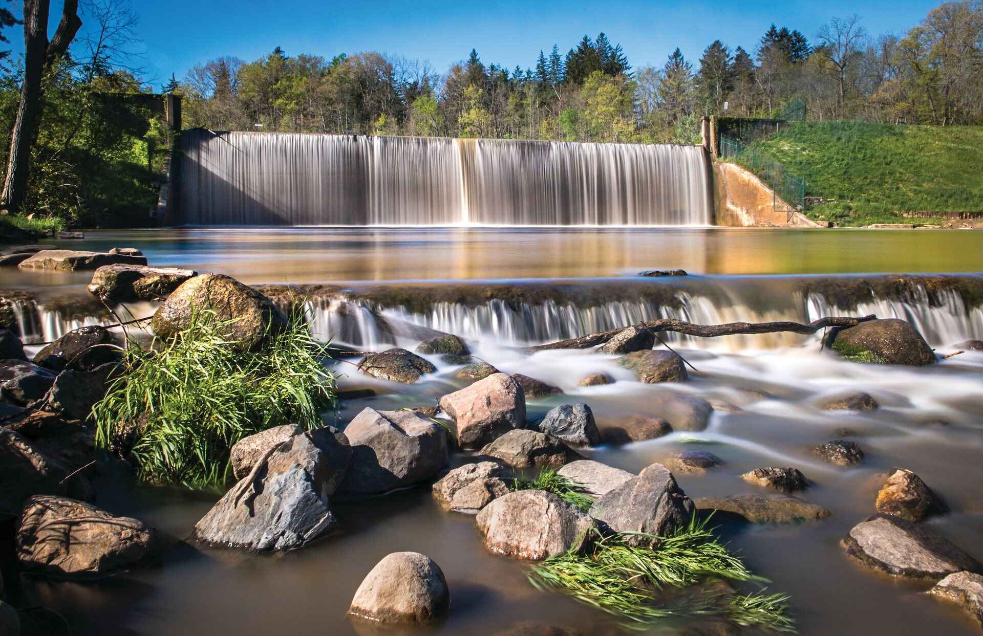 A waterfall into a pond with rocks