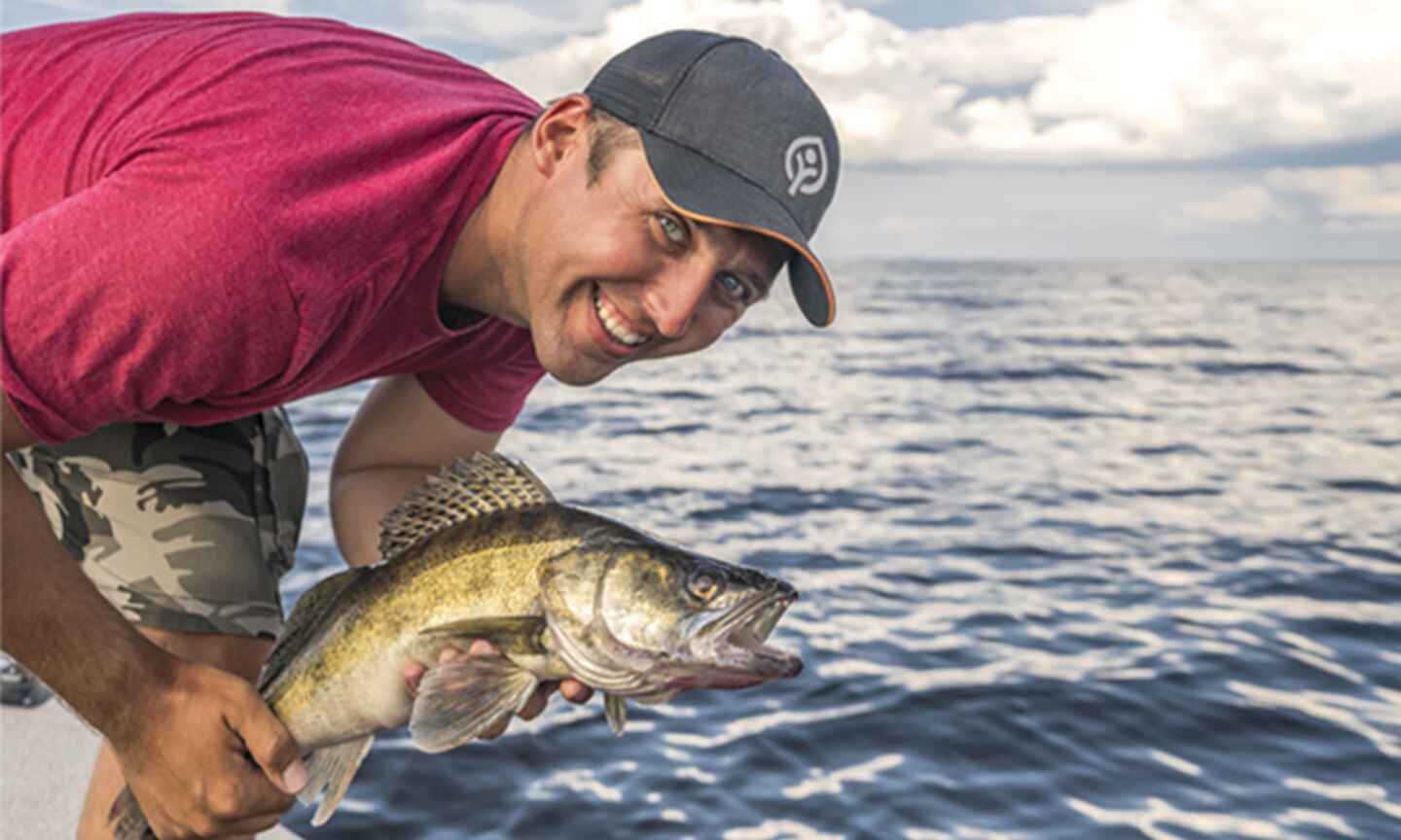 man smiling with a fish in his hands