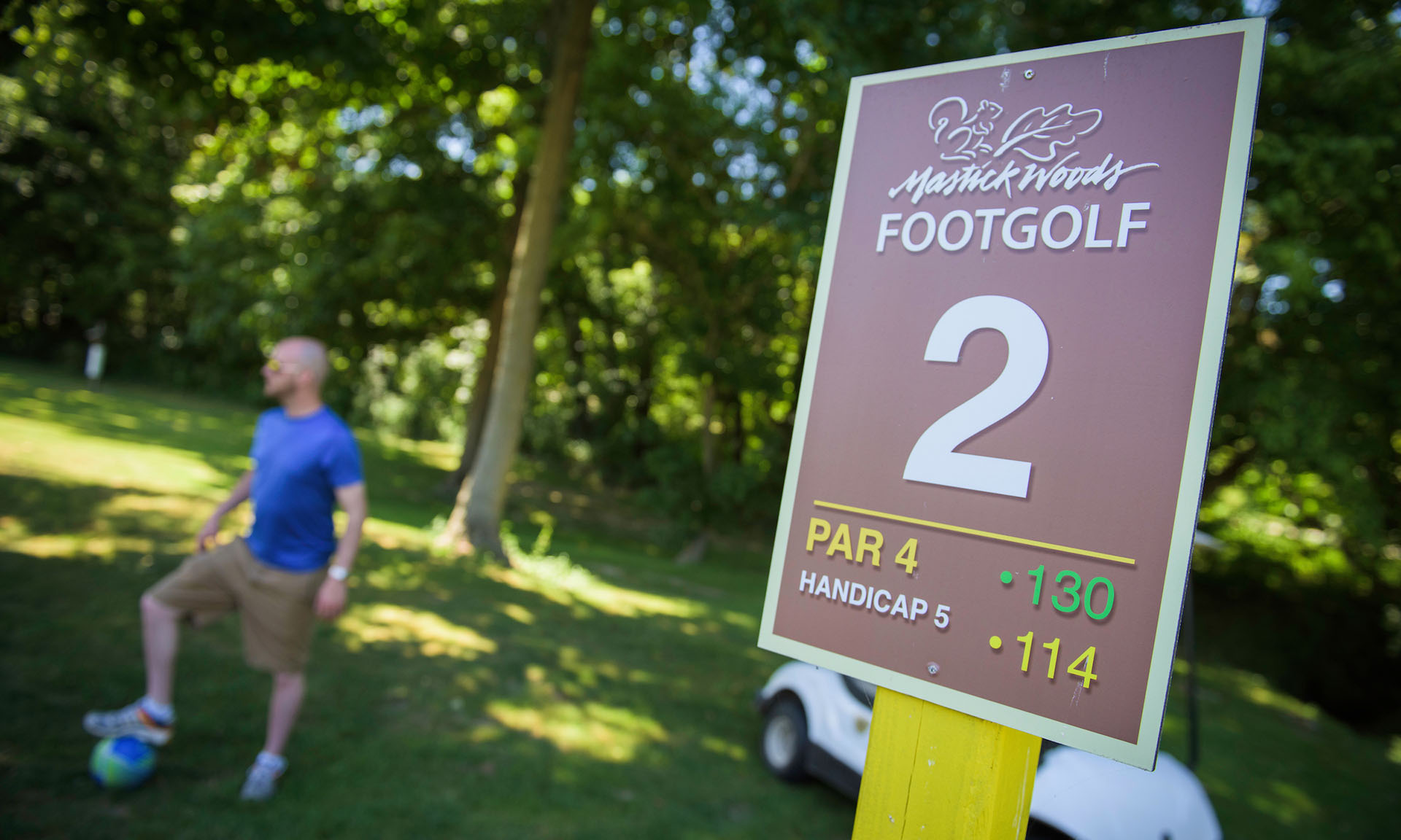 A man at a foot golf hole