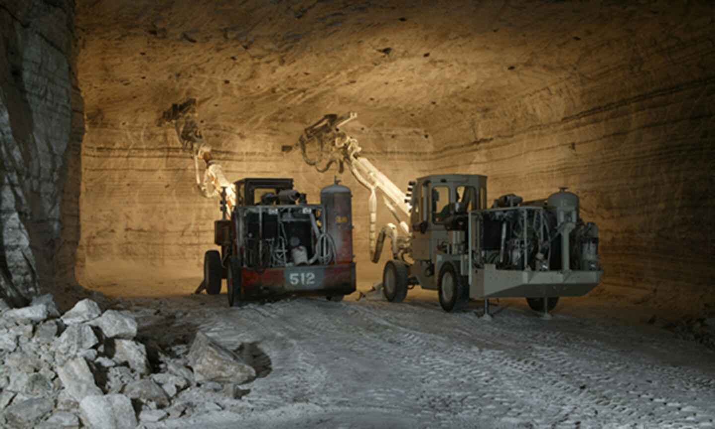 two machines mining salt in a cave