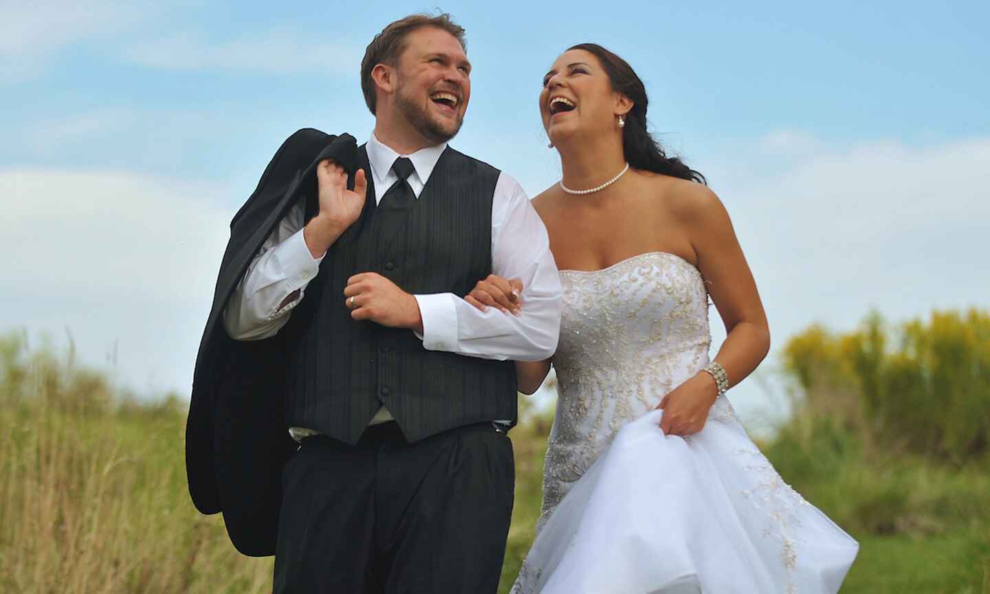 a happy couple in their wedding attire