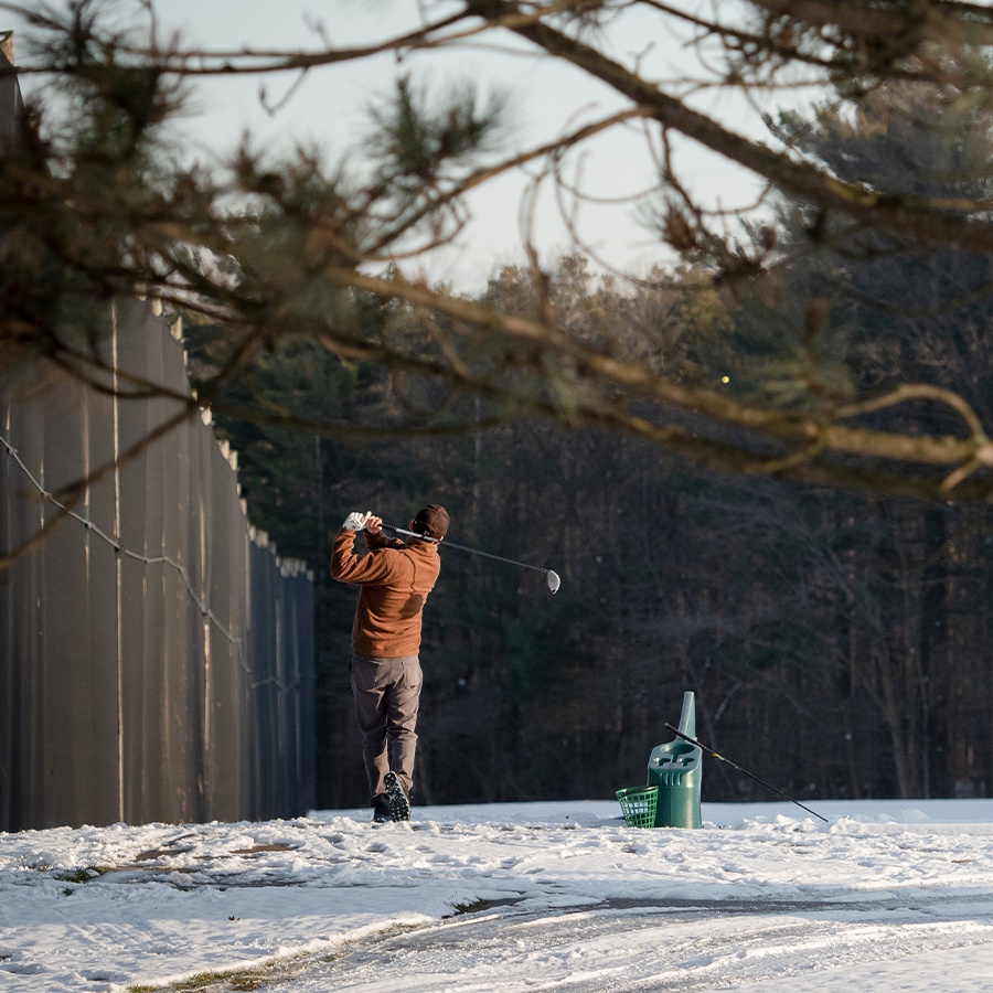 man golfing in winter