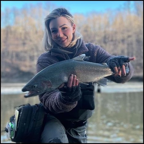 Woman smiling and holding a fish