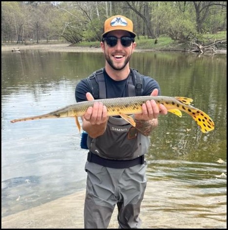 Man smiling and holding a fish