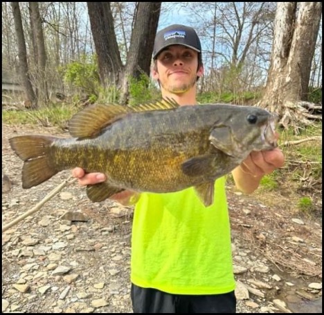 Man smiling and holding a fish