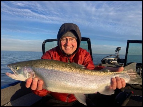 Man smiling and holding a fish