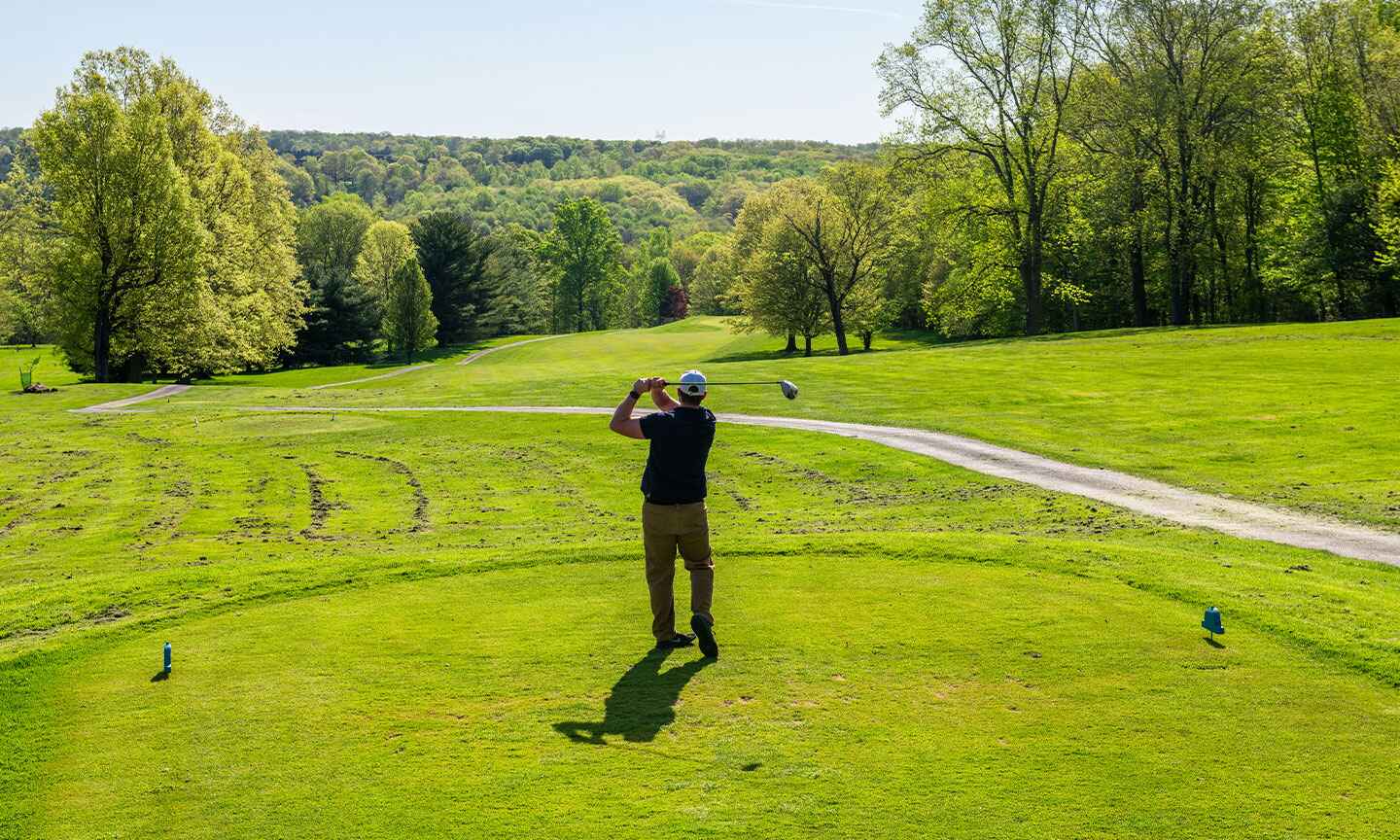 Man golfing on golf course