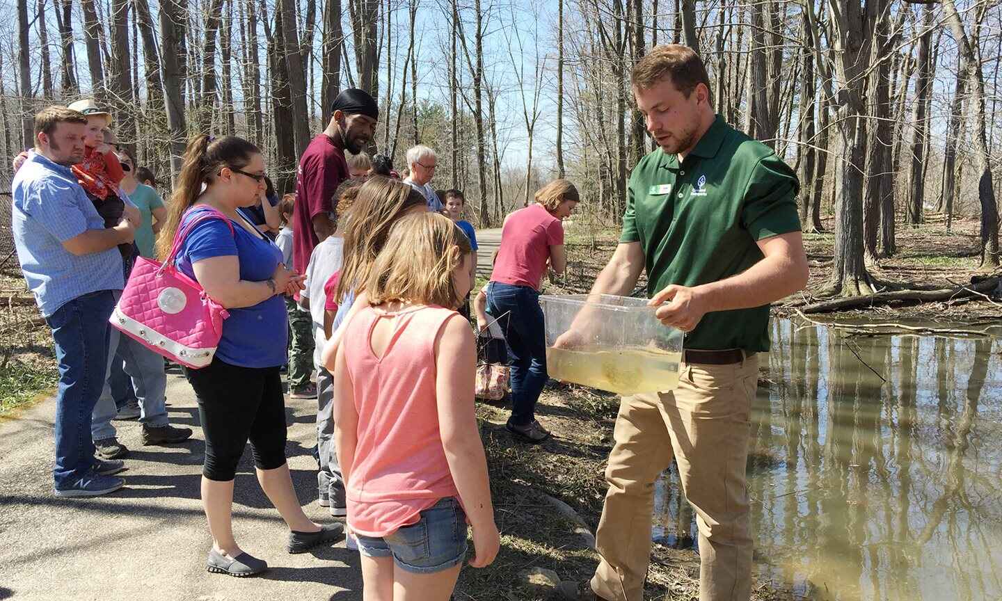 Worker teaching children about nature