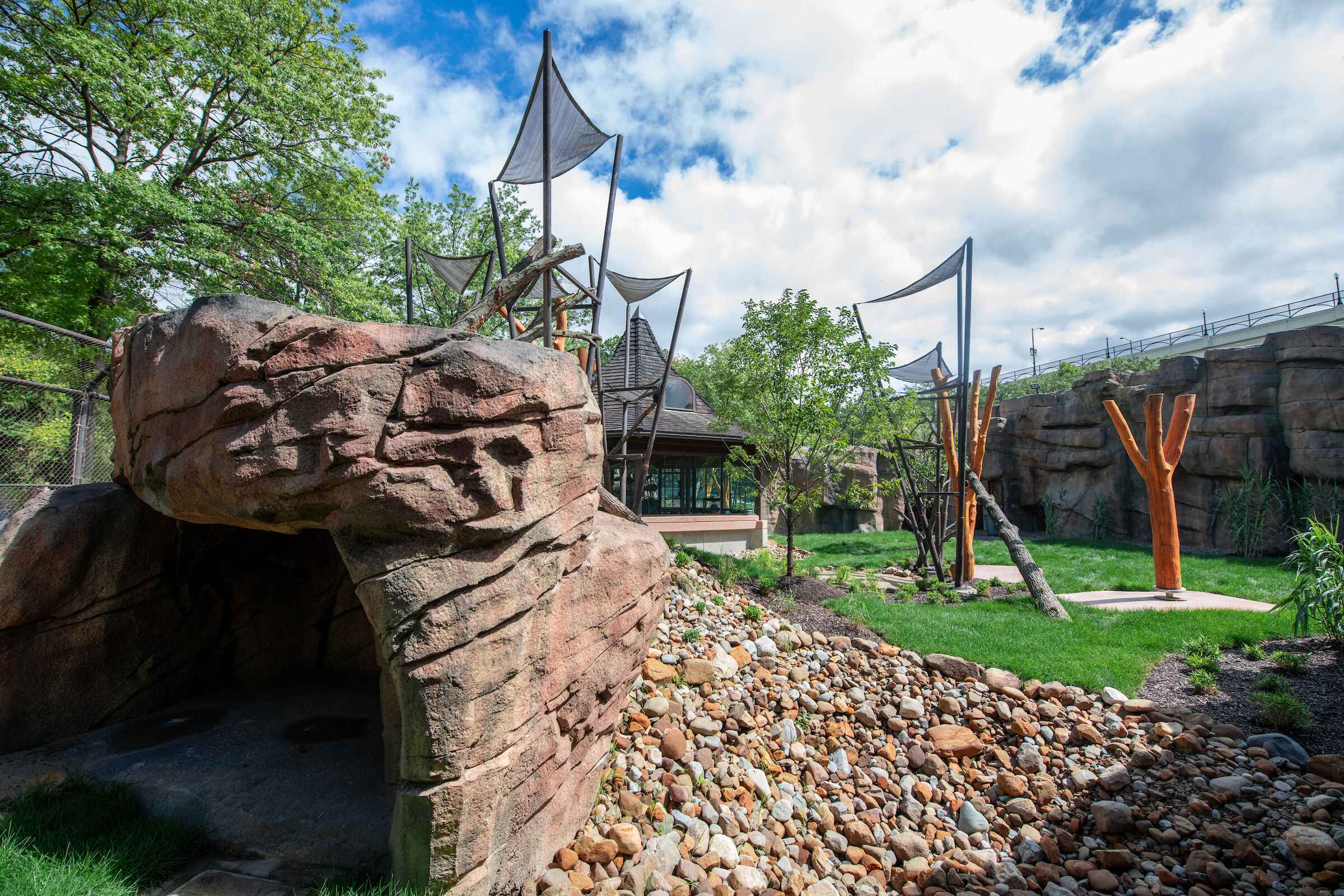 An animal exhibit at the zoo with rocks and branches