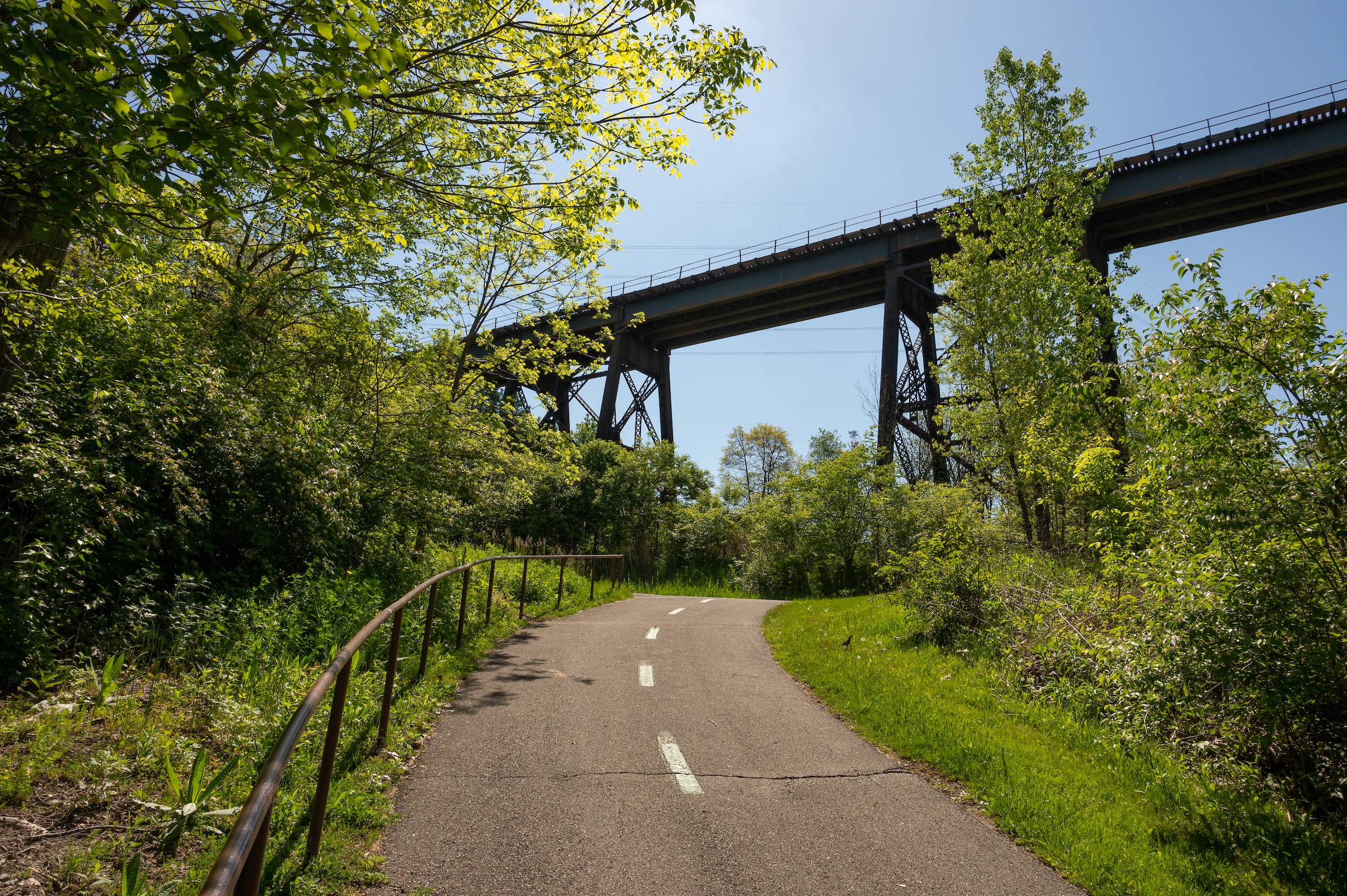 A neatly paved pathway leading through a picturesque area, perfect for outdoor activities and leisurely walks.