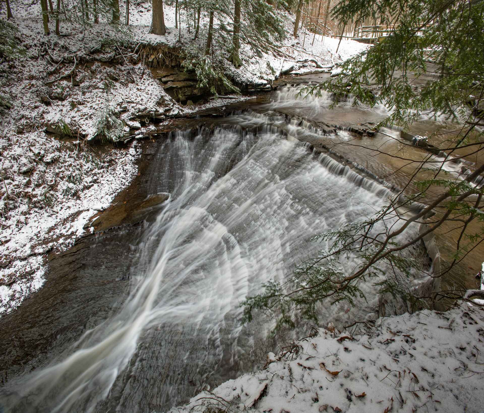 arafed waterfall in the woods with snow on the ground, a jigsaw puzzle by Jeff Miracola, shutterstock contest winner, regionalism, william penn state forest, hemlocks, beautiful winter area