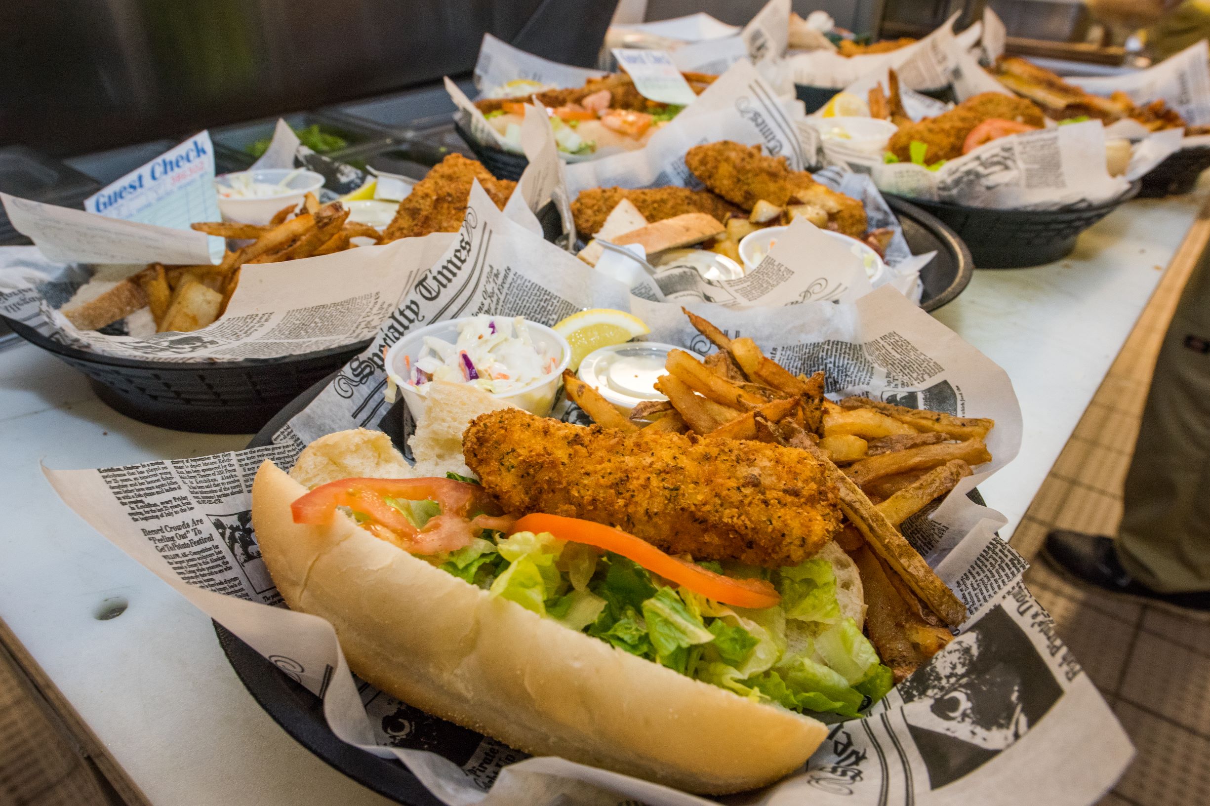 A grouping of fish places and fish sandwiches with sides. 