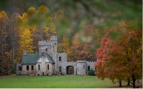 there is a castle like building with a tower in the middle of a field, a photo by Sydney Prior Hall, shutterstock contest winner, heidelberg school, magical castle school on a hill, castle on the mountain, brandywine school